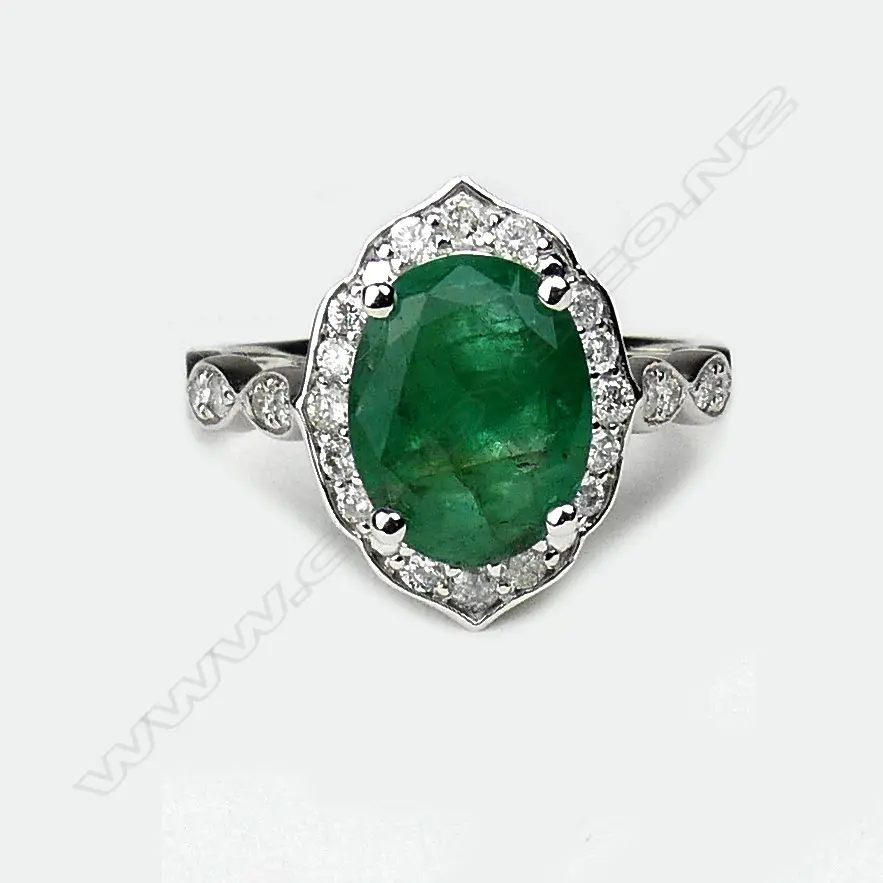 A 14ct white gold emerald and diamond ring Image 1++
