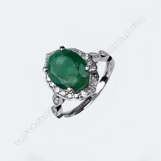 A 14ct white gold emerald and diamond ring