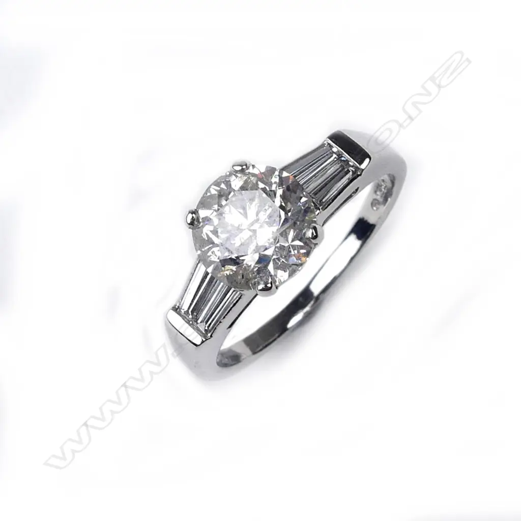 A platinum and diamond solitaire ring Image 1++