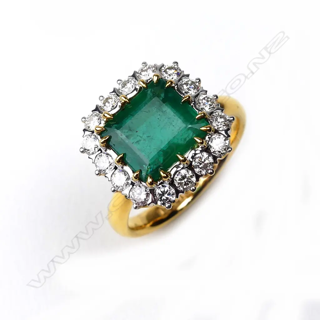 An 18ct yellow and white gold emerald and diamond ring Image 1++