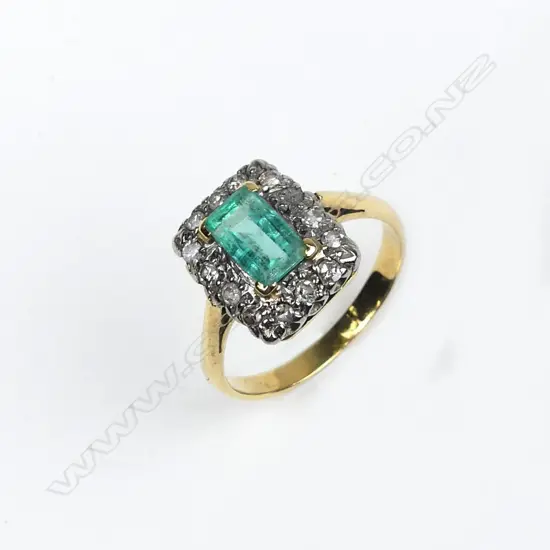 A lady's estate 18ct. yellow gold emerald and diamond ring