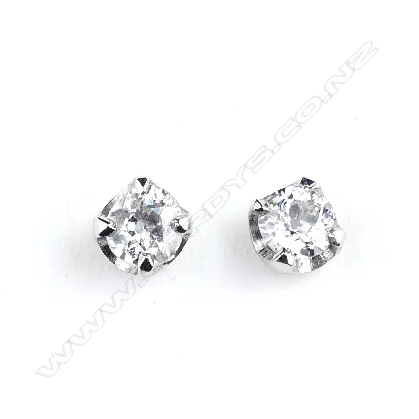 A pair of 9ct white gold and diamond stud earrings Image 1++