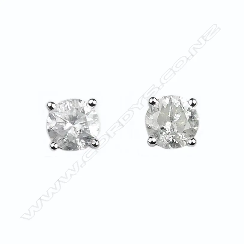 A pair of 14ct white gold and diamond stud earrings Image 1++