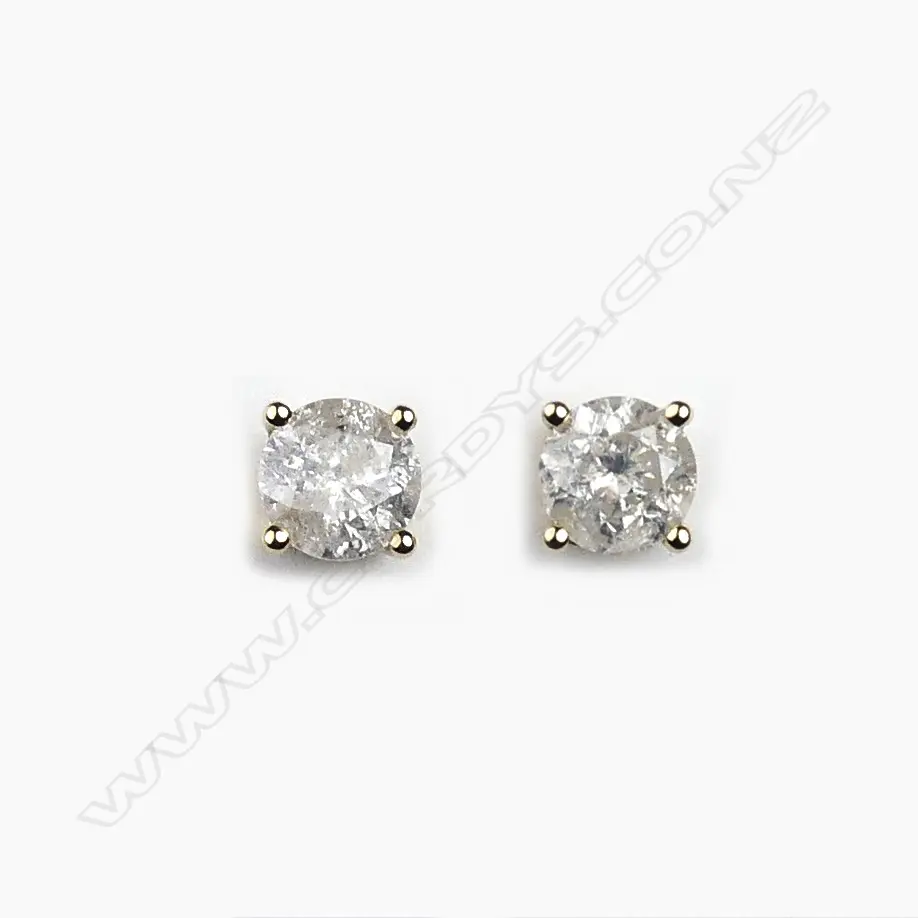 A pair of 14ct gold and diamond stud earrings Image 1++