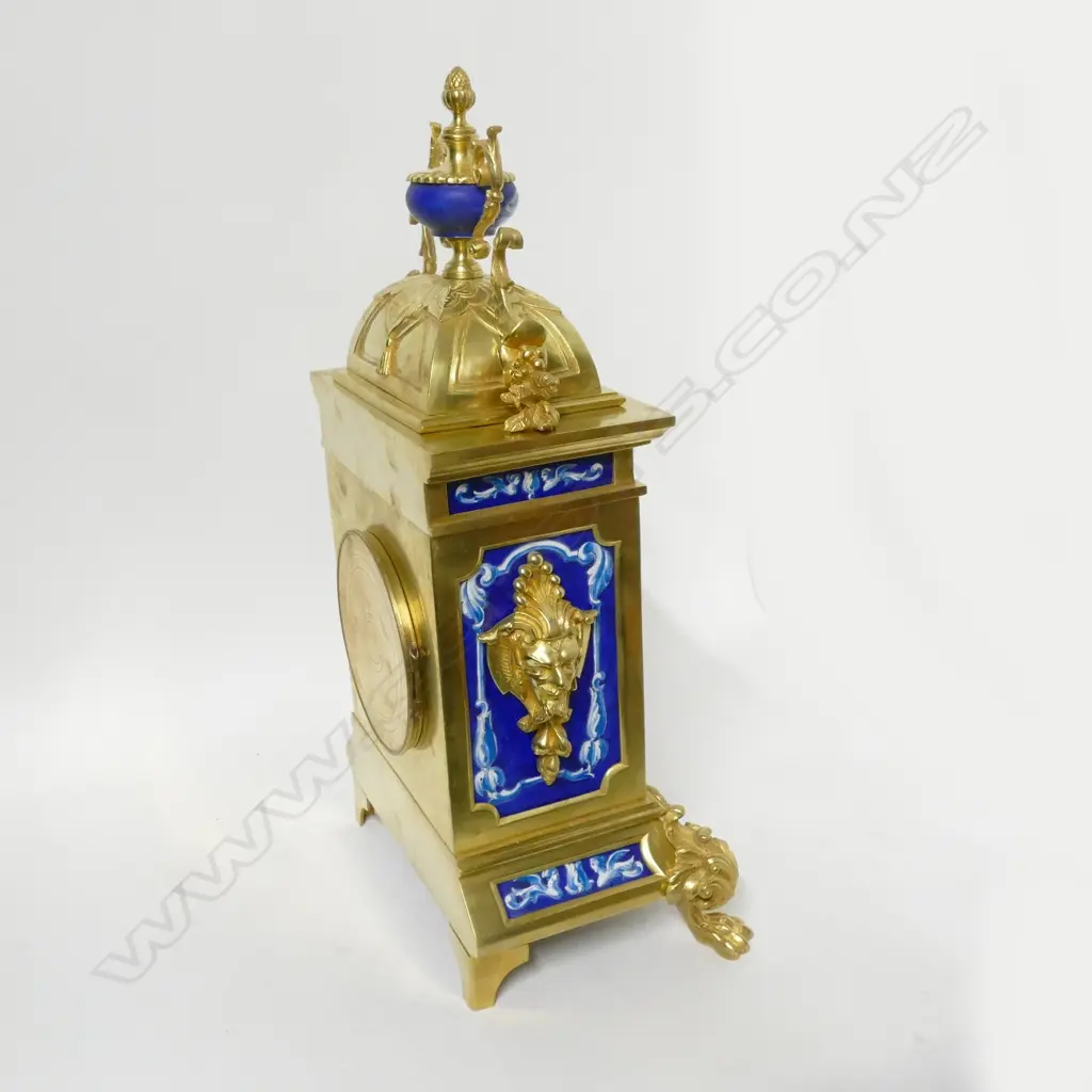 A decorative French mantel clock with blue and white porcelain panelled brass case Image 1++