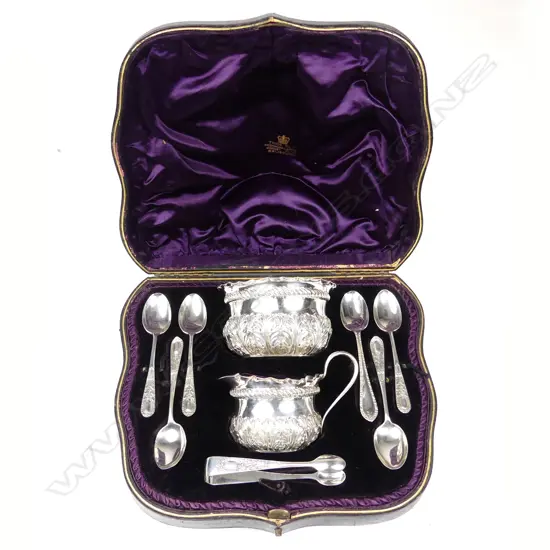 A cased Victorian silver set of sugar basin cream jug six spoons and a pair of tongs