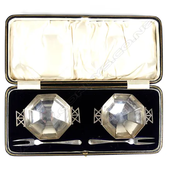 A pair of small silver octagonal petit fours dishes and forks