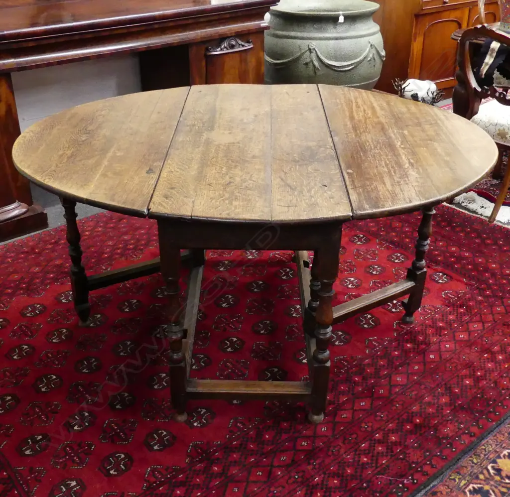 A late Georgian oak drop leaf table Image 1++