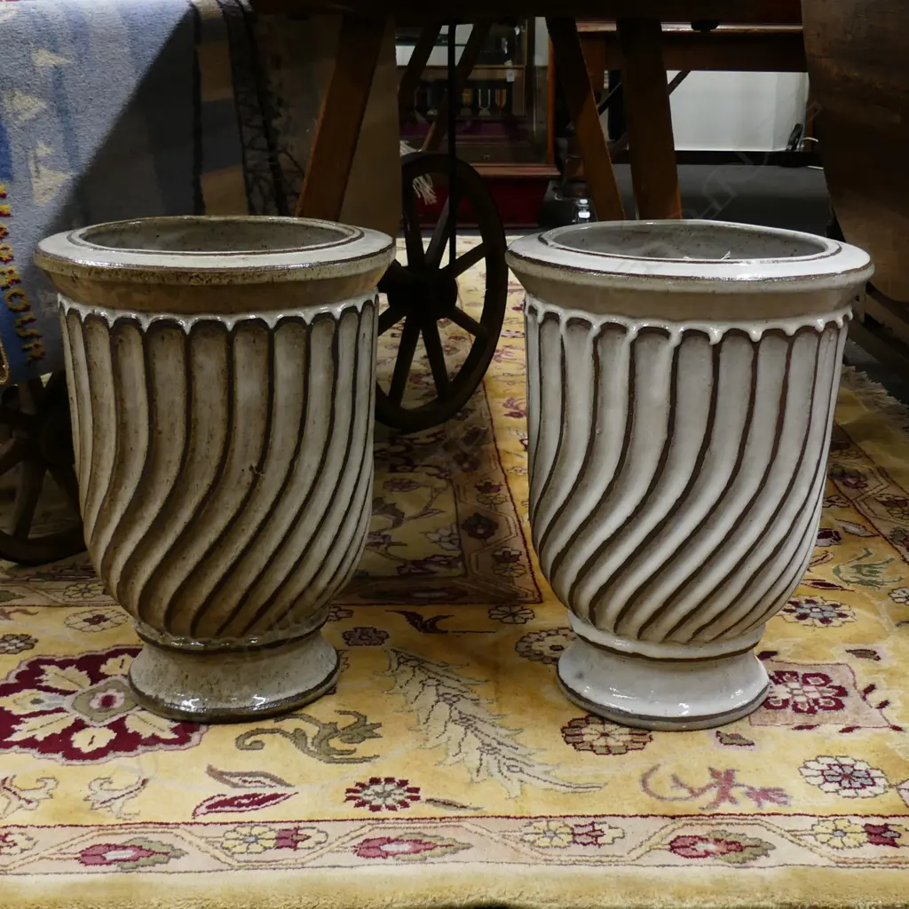 A pair of white glazed pottery garden urns Image 1++