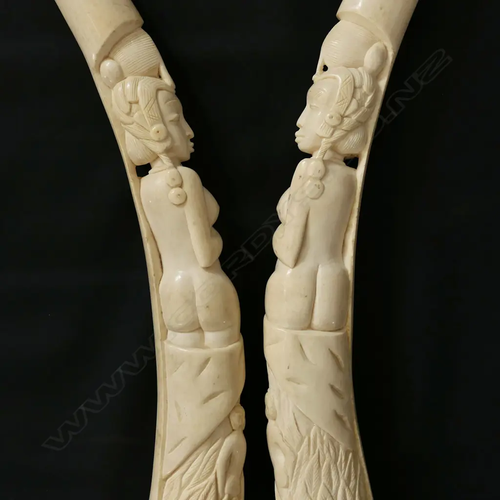 A pair of old African carved ivory tusks carved with a naked woman Image 1++