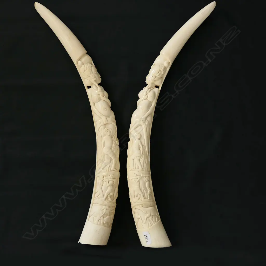 A pair of old African carved ivory tusks carved with a naked woman Image 1++