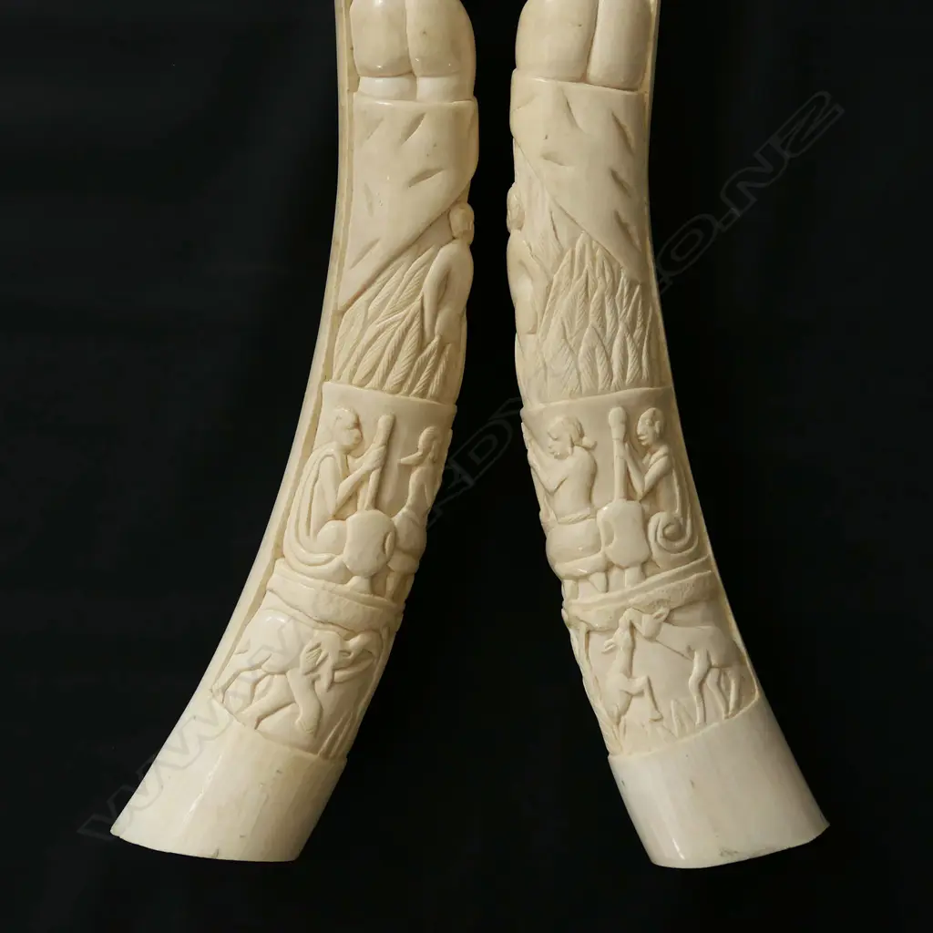 A pair of old African carved ivory tusks carved with a naked woman Image 1++