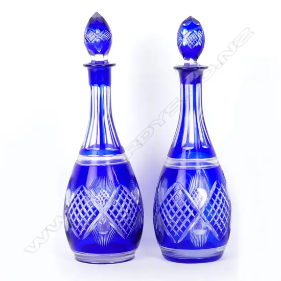 A pair of blue overlay cut crystal decanters