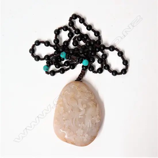 A Chinese pale jade carved boulder pendant