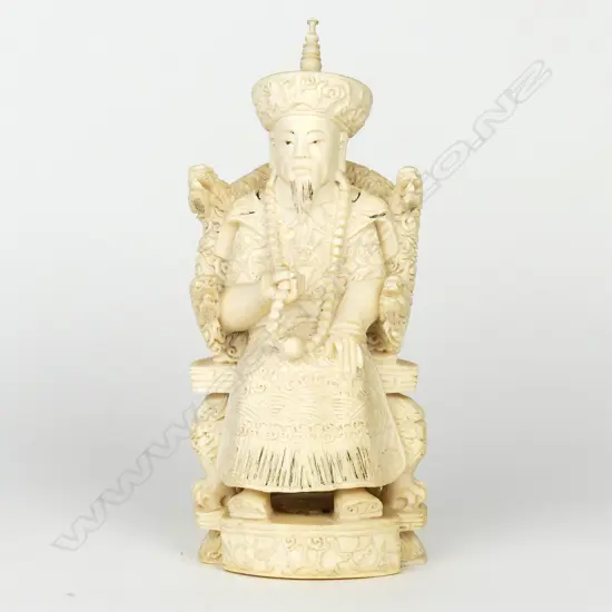 A Chinese old carved ivory figure of a seated emperor