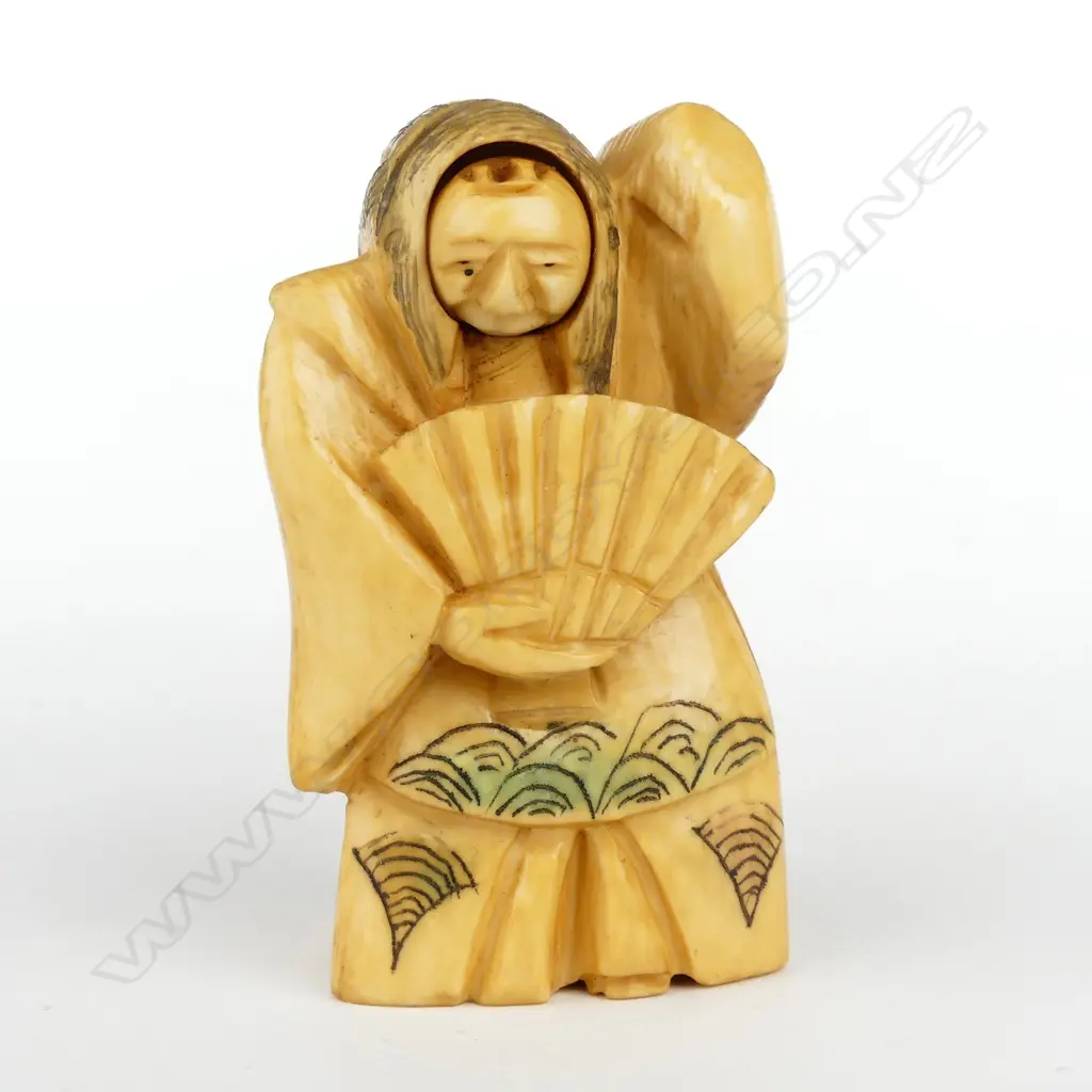 A Japanese old carved ivory netsuke of a woman Image 1++