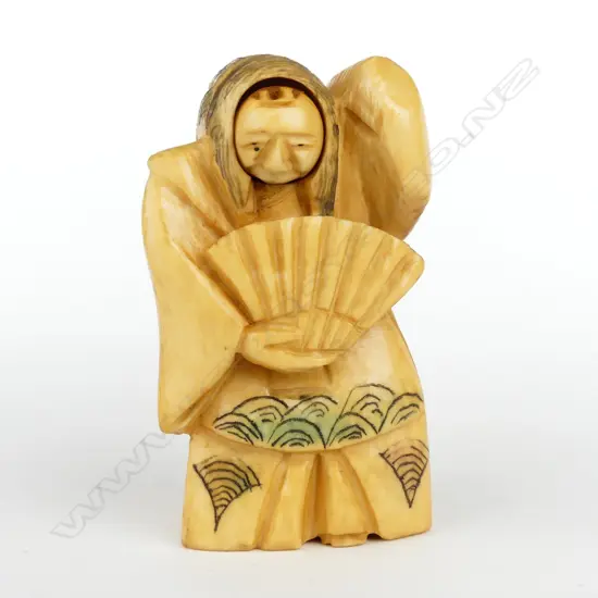 A Japanese old carved ivory netsuke of a woman