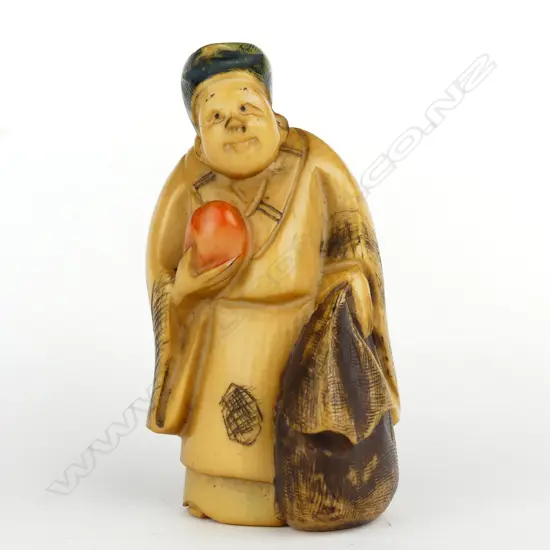 A Japanese old carved ivory netsuke of a woman