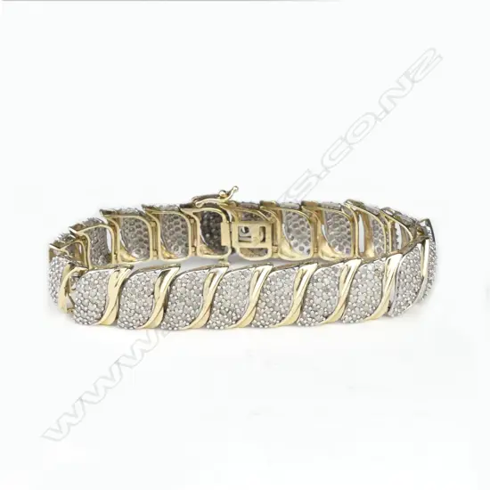 A 10ct yellow gold and multi-diamond set bracelet