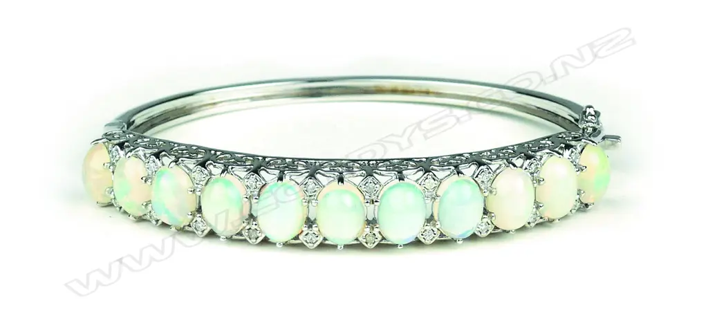 A 14ct white gold opal and diamond hinged bangle Image 1++