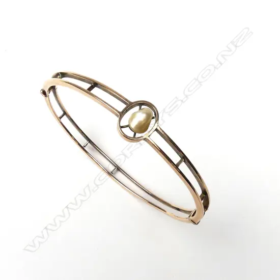 An estate 9ct rose gold hinged bangle
