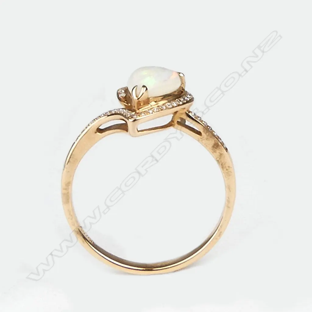 An 18ct. rose gold opal and diamond modern ring Image 1++