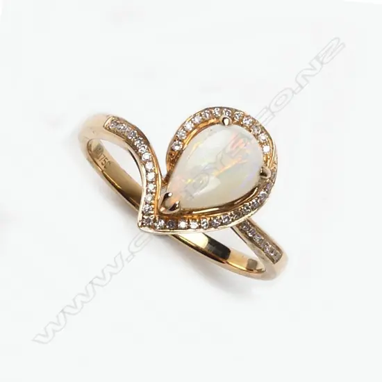 An 18ct. rose gold opal and diamond modern ring