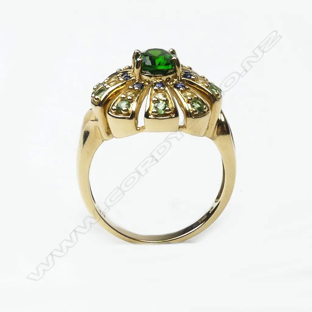 An 18ct. yellow gold green topaz centred multi-stone cocktail ring Image 1++