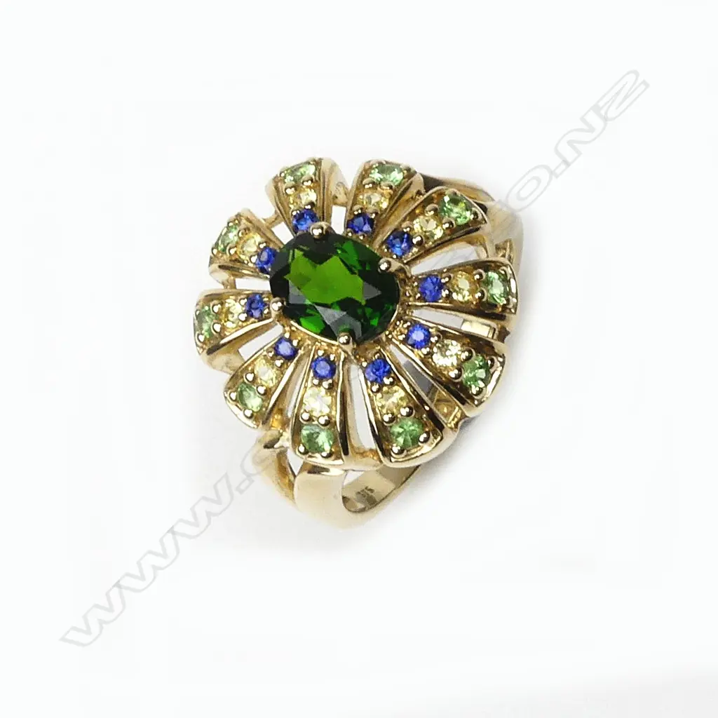 An 18ct. yellow gold green topaz centred multi-stone cocktail ring Image 1++