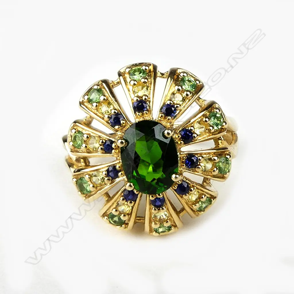An 18ct. yellow gold green topaz centred multi-stone cocktail ring Image 1++