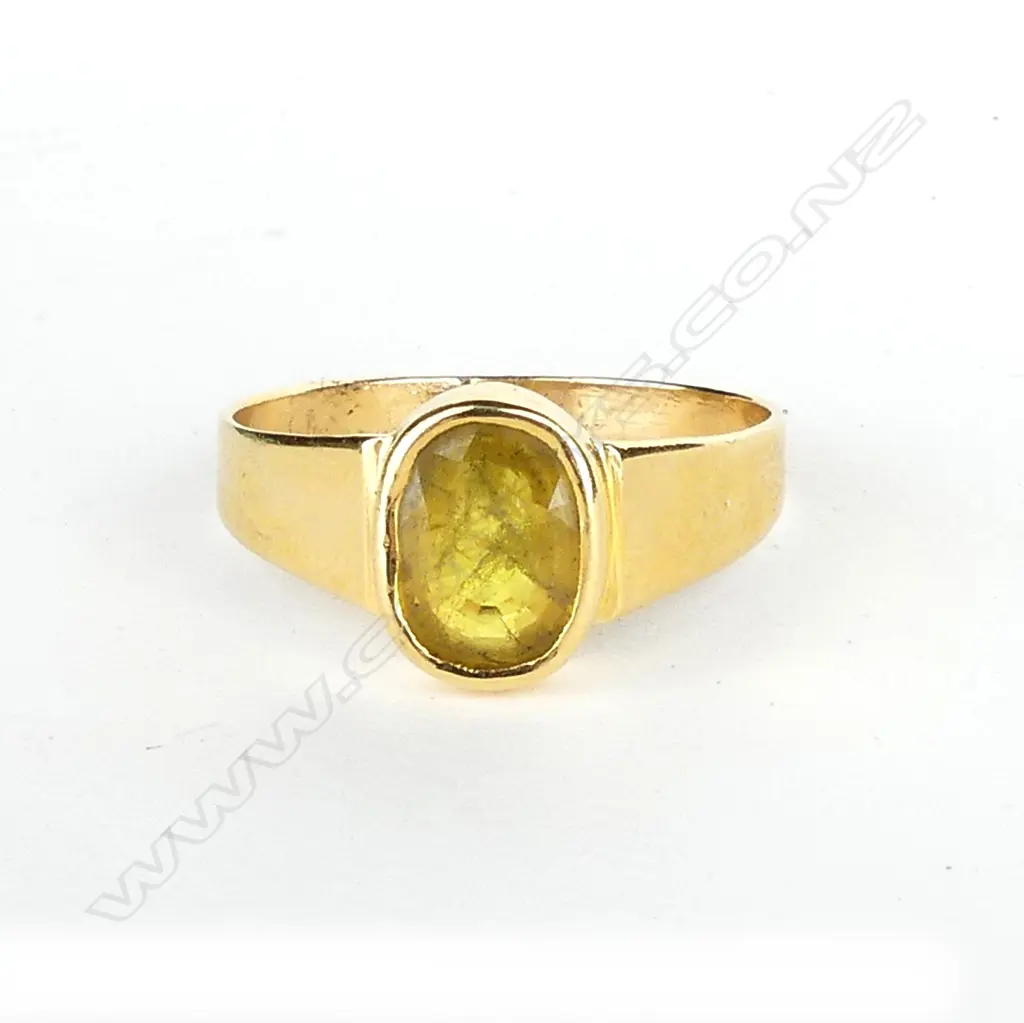 An 18ct gold and golden sapphire ring Image 1++