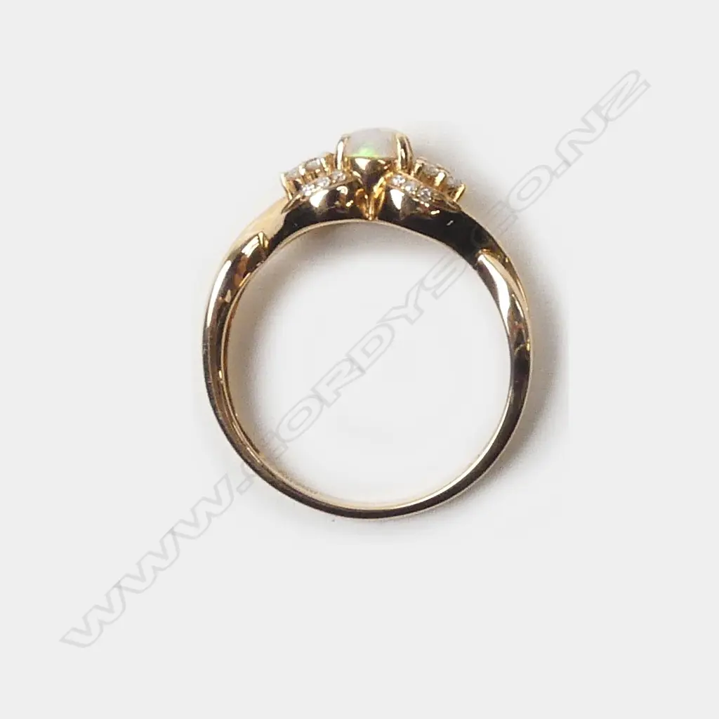 A modern 18ct. rose gold opal and diamond dress ring Image 1++