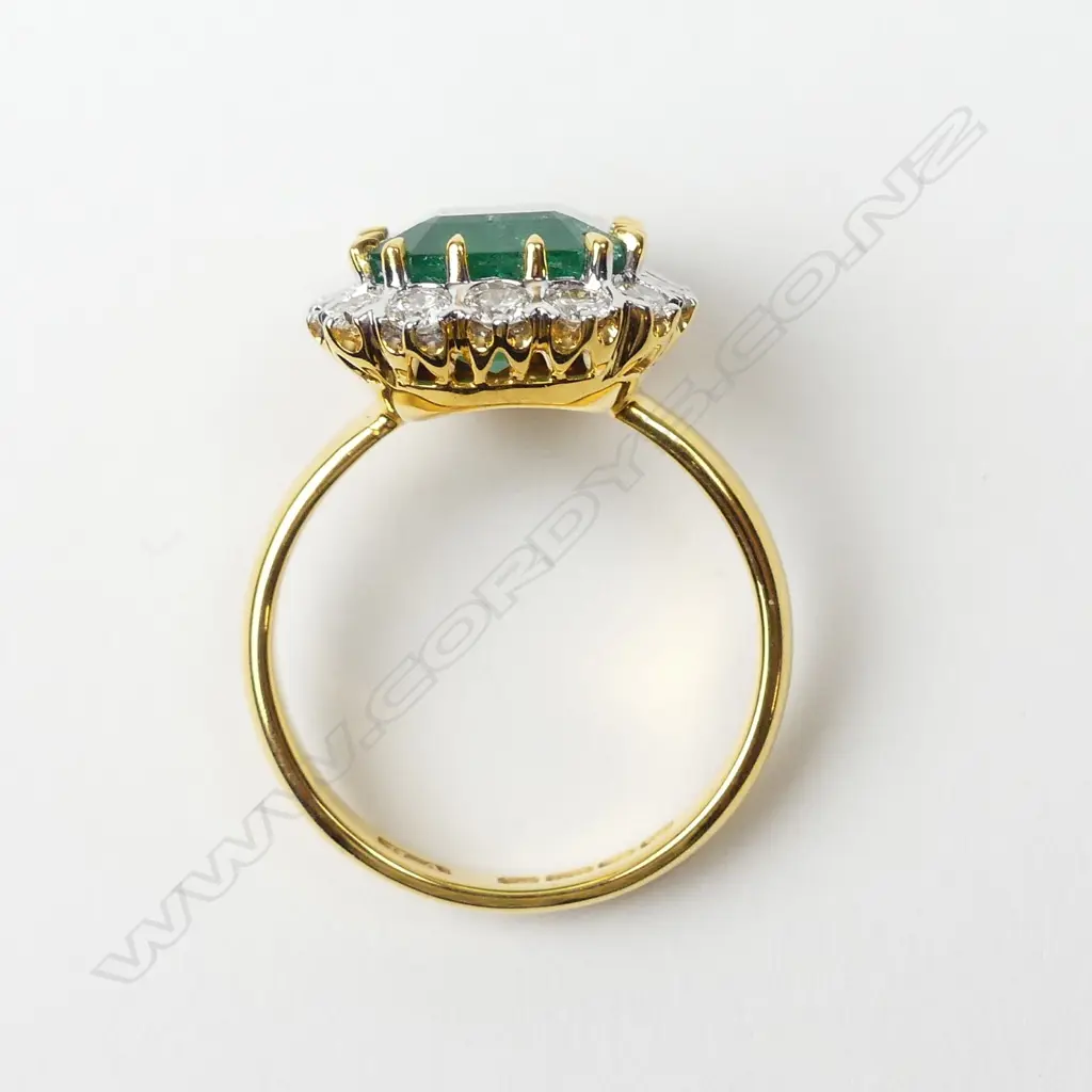 An 18ct yellow and white gold emerald and diamond ring Image 1++