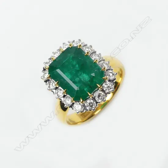 An 18ct yellow and white gold emerald and diamond ring