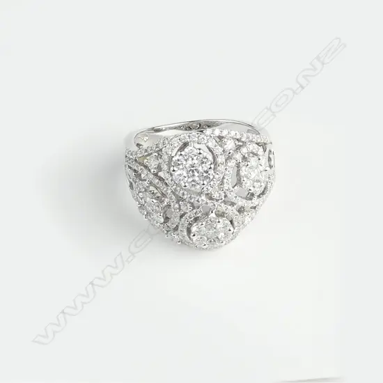 An 18ct. white gold wide multi-diamond cluster set ring