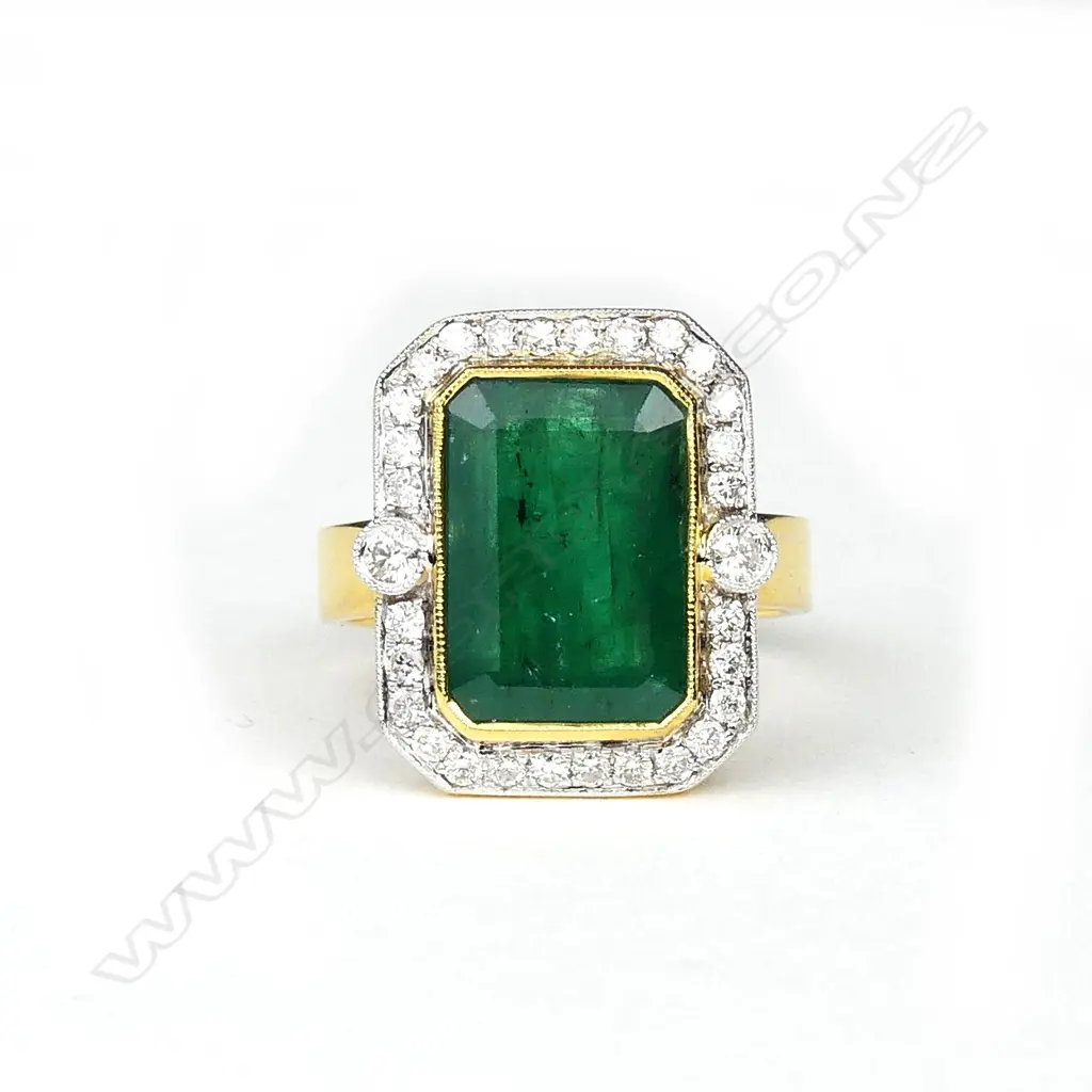 An 18ct yellow and white gold emerald and diamond ring Image 1++