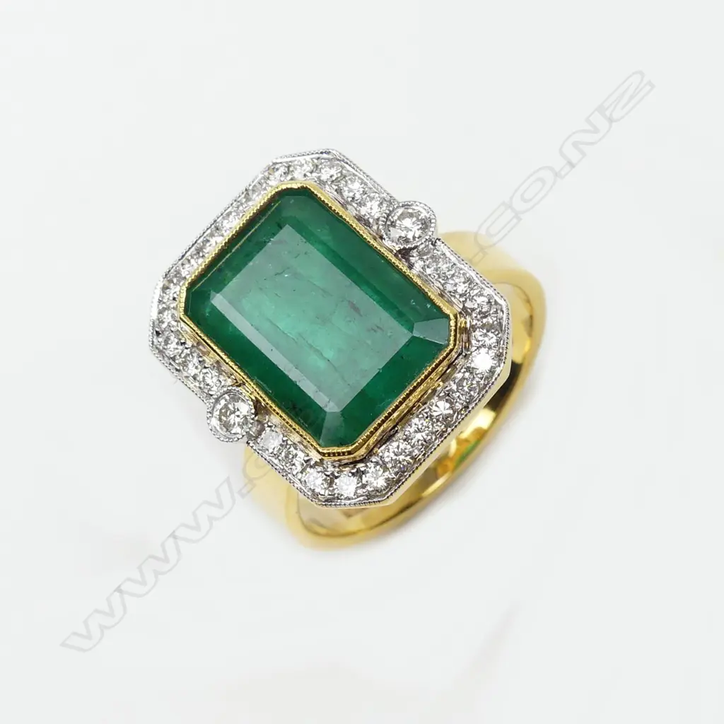 An 18ct yellow and white gold emerald and diamond ring Image 1++