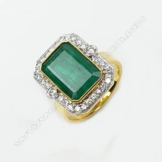 An 18ct yellow and white gold emerald and diamond ring