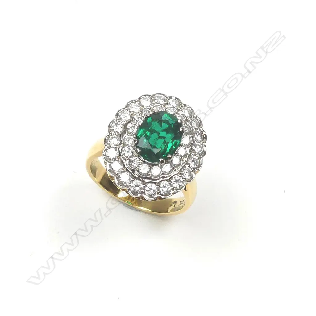An impressive 18ct. yellow and white gold emerald and multi-diamond cluster ring Image 1++