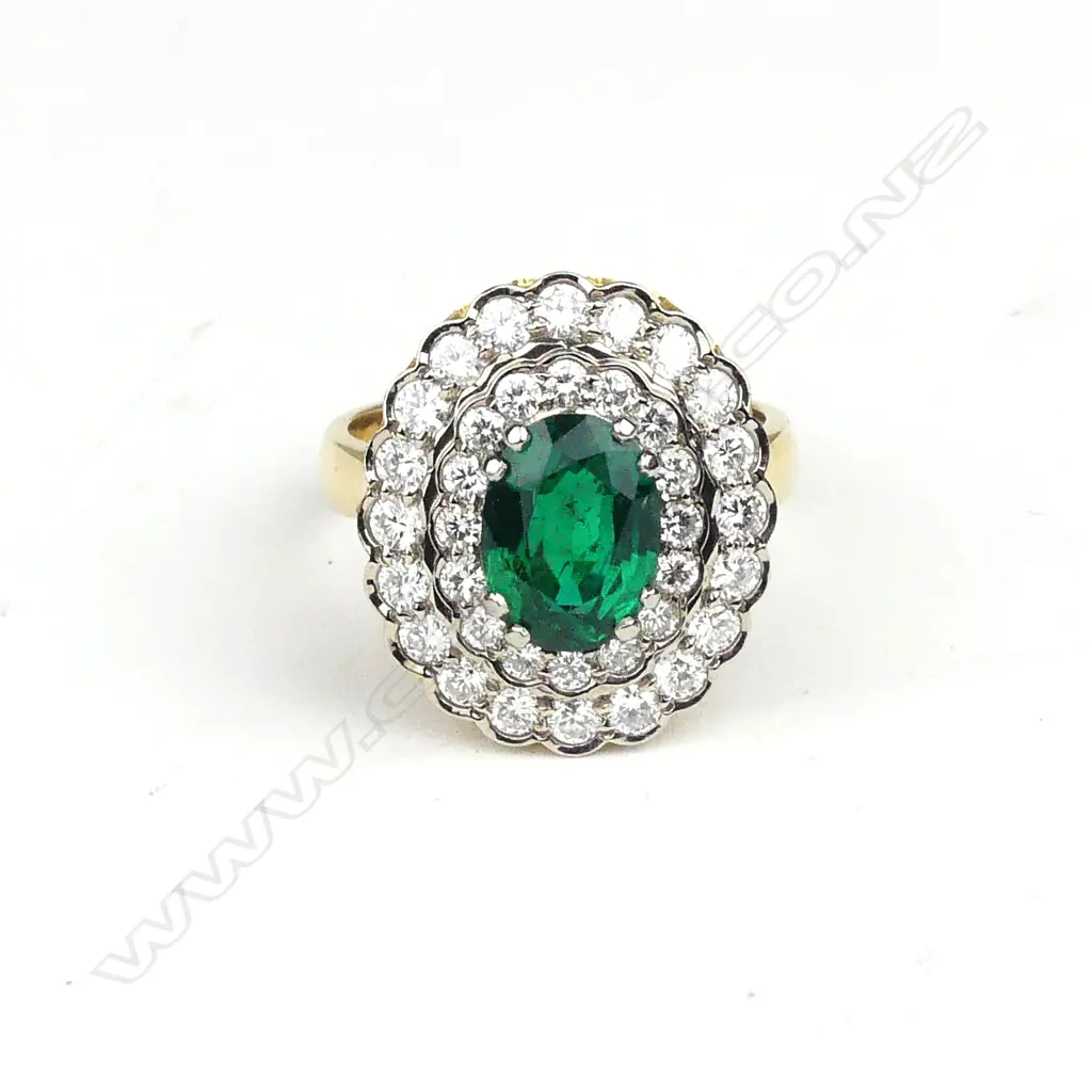 An impressive 18ct. yellow and white gold emerald and multi-diamond cluster ring Image 1++