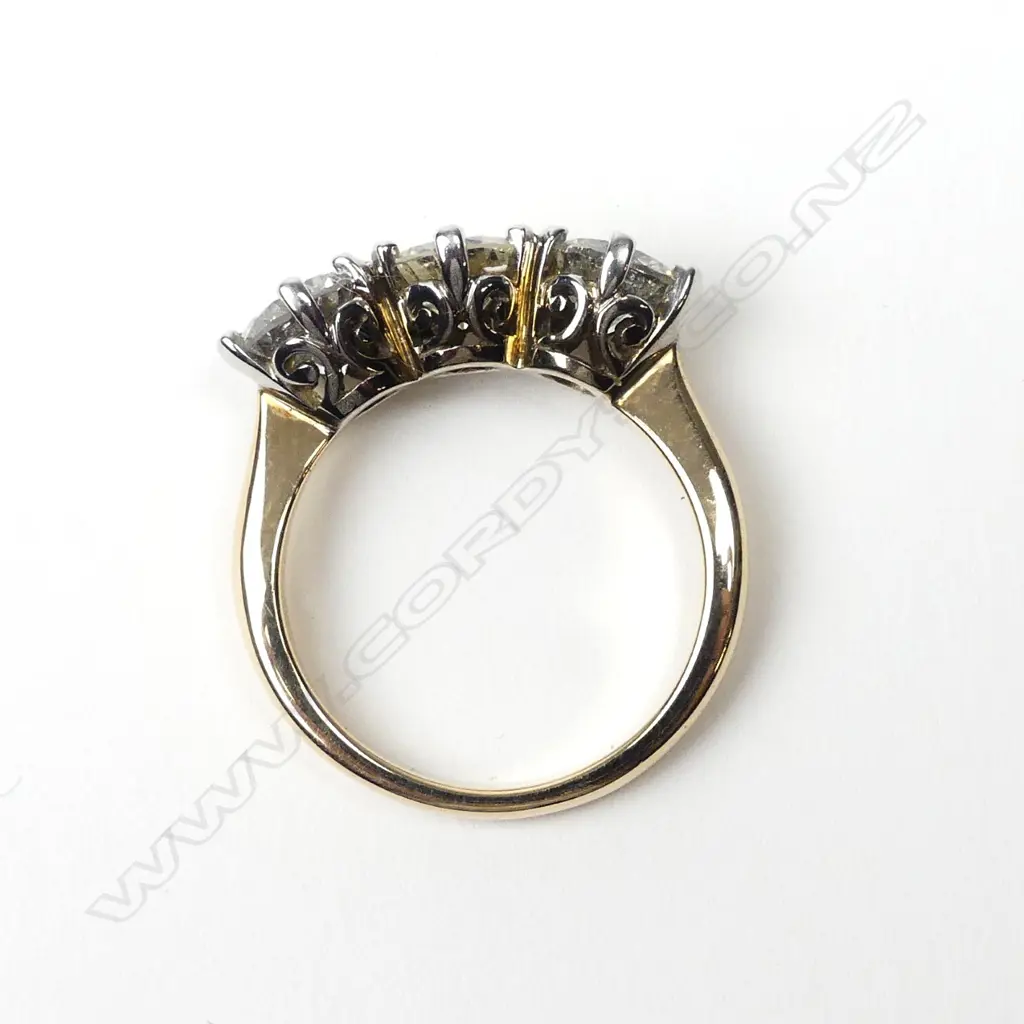 An 18ct yellow and white gold diamond trilogy ring Image 1++