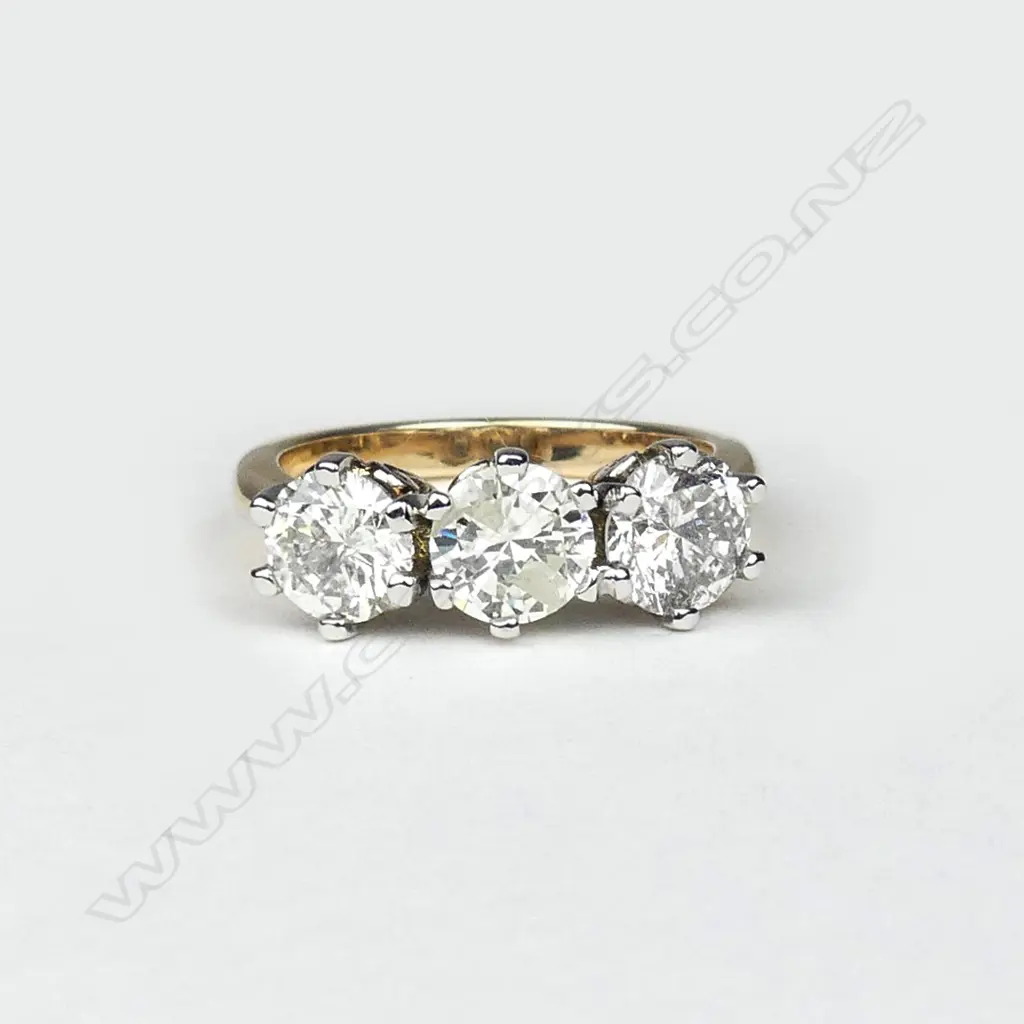 An 18ct yellow and white gold diamond trilogy ring Image 1++