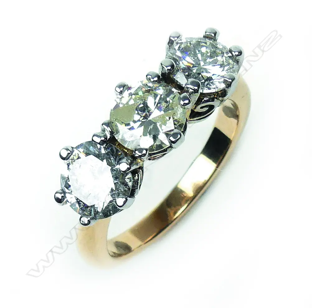 An 18ct yellow and white gold diamond trilogy ring Image 1++