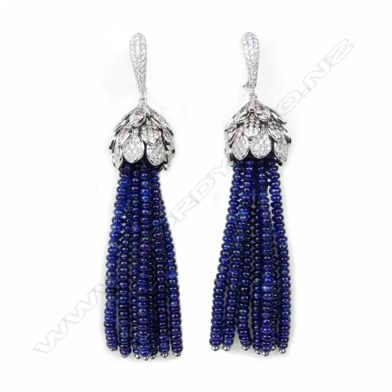 A pair of modern designer 18ct. white gold diamond and sapphire tassel drop earrings