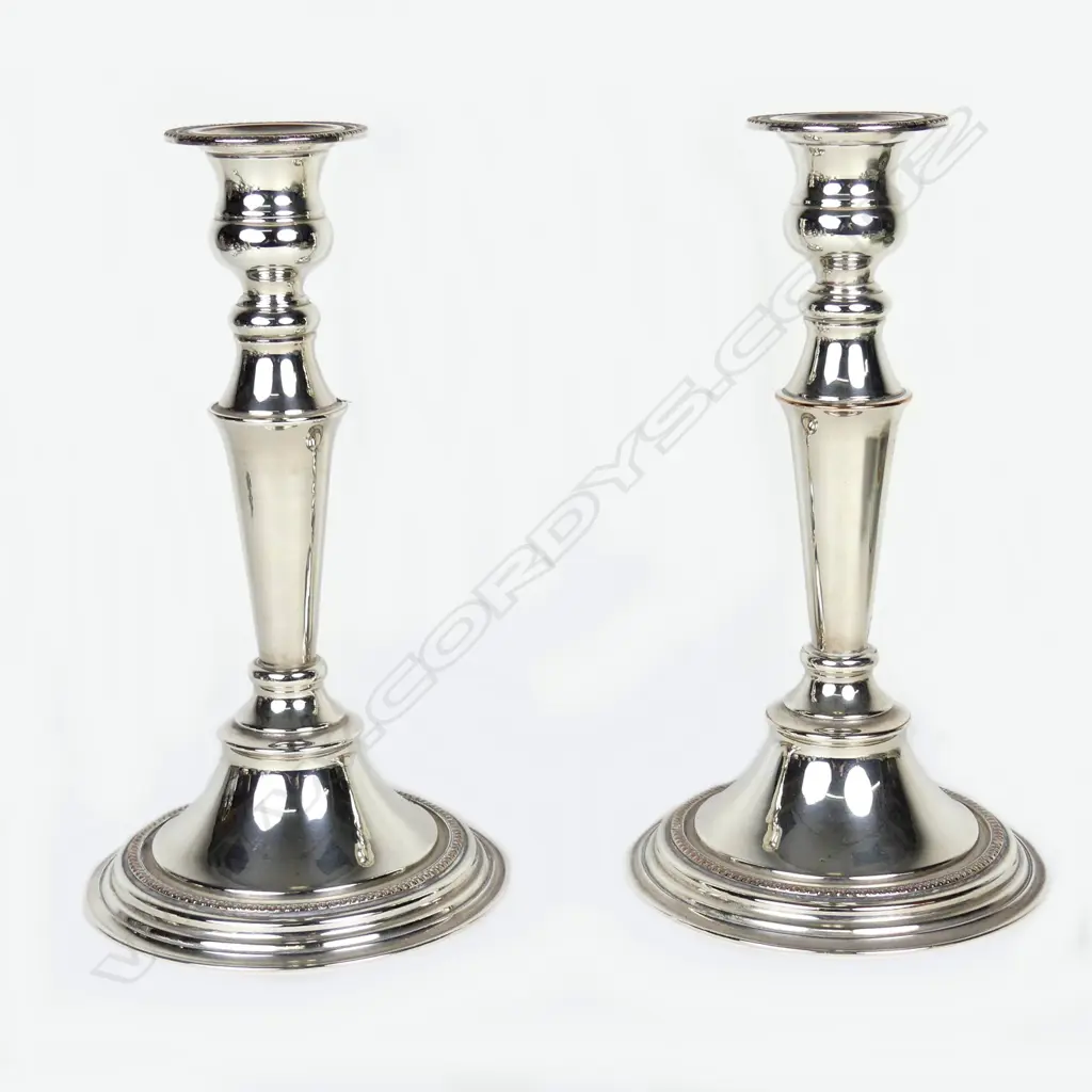A pair of modern silver over copper candlesticks Image 1++
