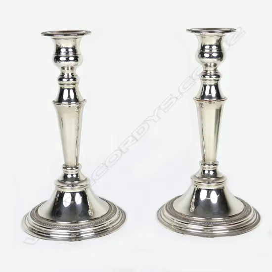 A pair of modern silver over copper candlesticks