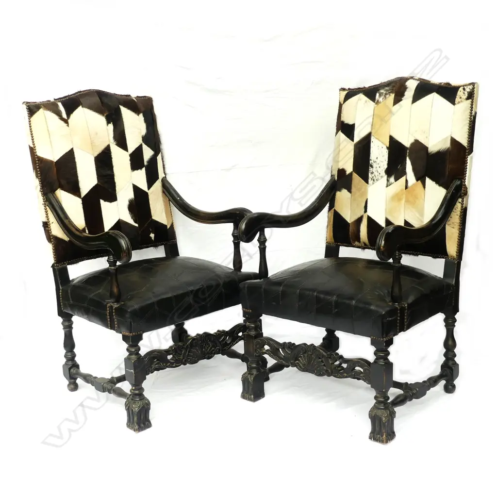 A pair of ebonised beech framed baronial armchairs Image 1++