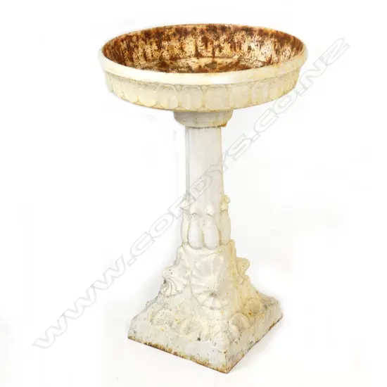 A cast iron birdbath/planter
