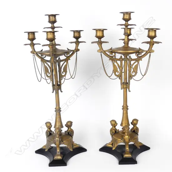 A pair of French Empire gilt metal table candelabra