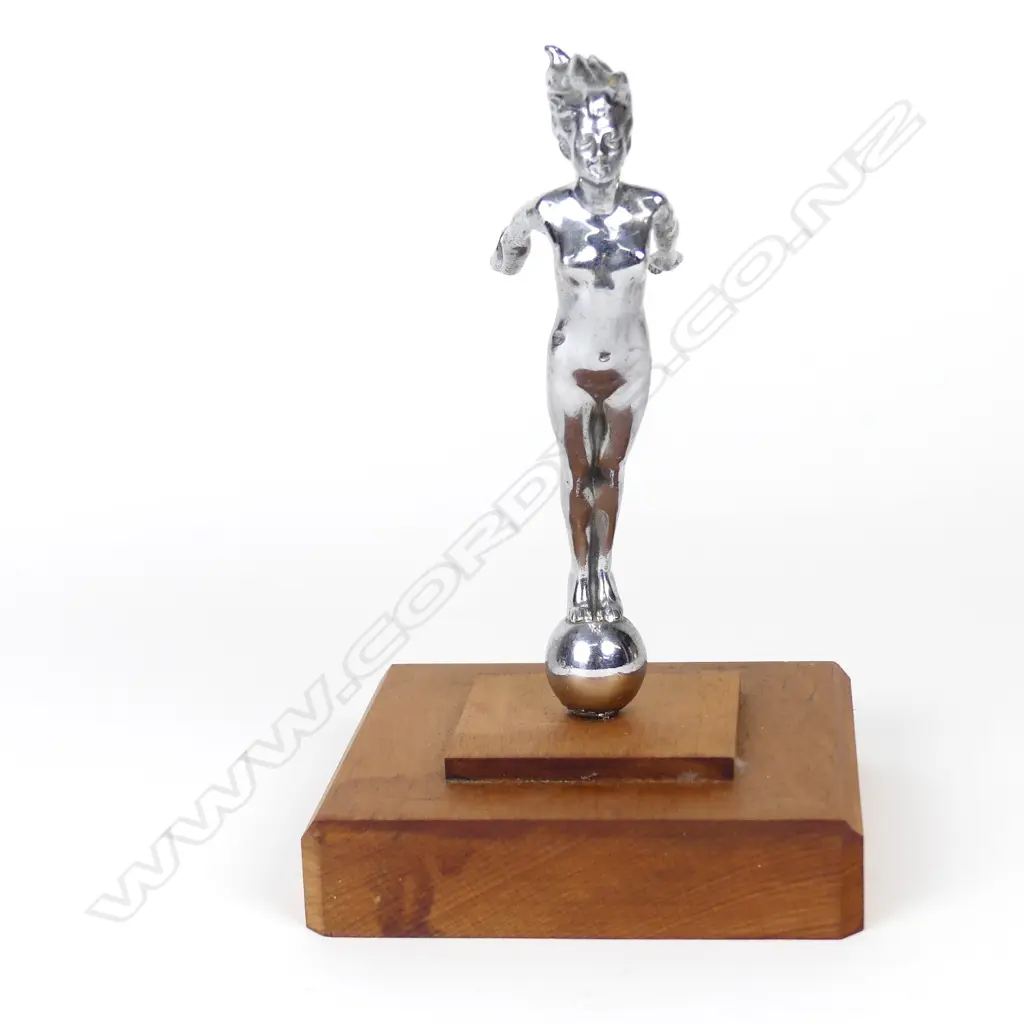 A vintage car mascot of a chromed naked woman Image 1++